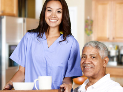 Caregiver bringing meal to elderly