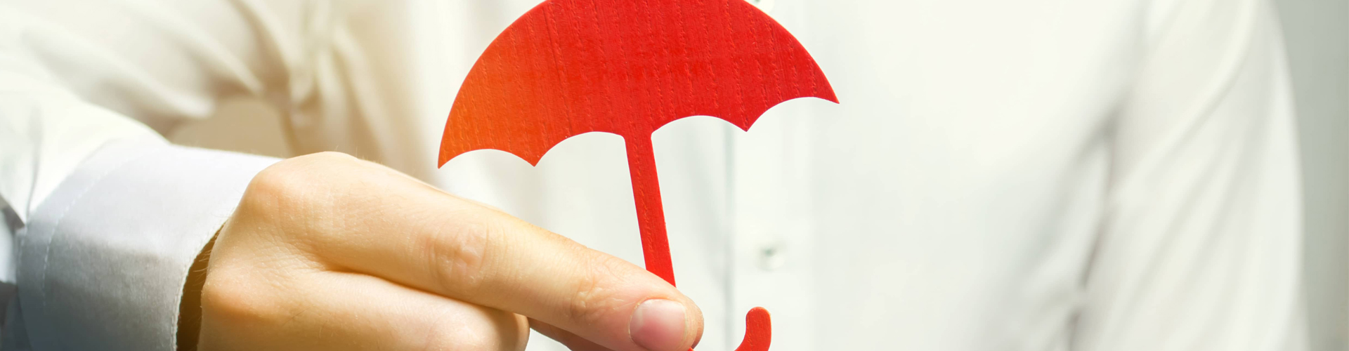 hand holding out a small red umbrella cutout