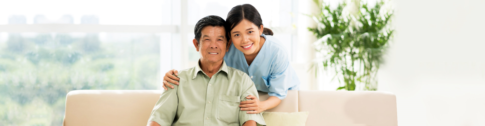 Caregiver smiling together with elderly man